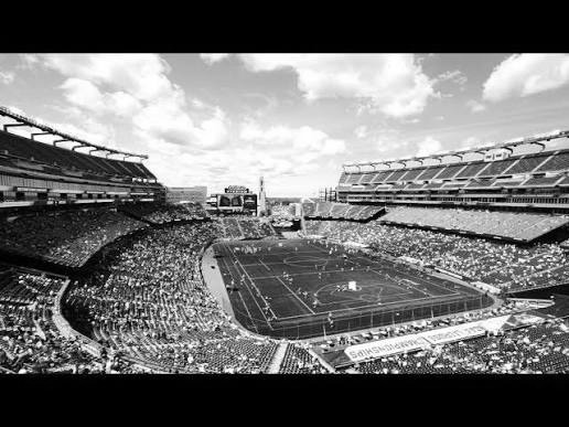 Packed stadium during a lacrosse championship game, black and white